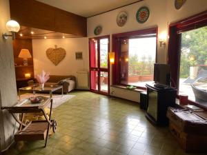 a living room with a couch and a tv in it at Villa Rama in Aci Castello