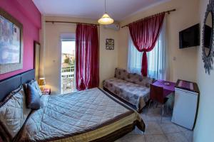 a bedroom with a bed and a table and a window at Iliadis House in Sarti