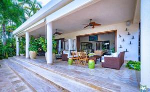 a house with a patio with furniture and a ceiling fan at Holiday Villa 27 in La Romana