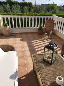 a patio with a white fence and a table at Villa Zose' luz in Káto Ássos