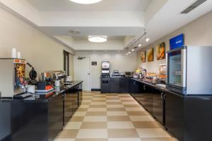 a large room with a cafeteria with counters and appliances at Comfort Inn Plano-Dallas in Plano