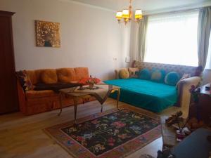 a living room with a couch and a table at Apartamentai in Tauragė
