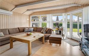 a living room with a couch and a table at Lovely Home In Hejls With Sauna in Hejls