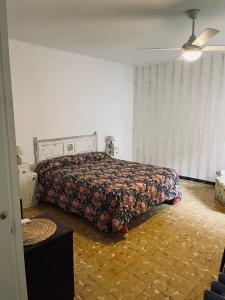 a bedroom with a bed with a comforter on it at Casa iaia in Monistrol