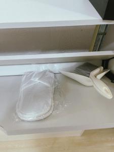 a drawer with a plastic bag and a pair of scissors at Kota Bharu RS Desa Roomstay in Kampong Haji Musa