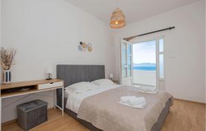 a bedroom with a bed with a desk and a window at 1 Bedroom Awesome Apartment In Podaca in Podaca