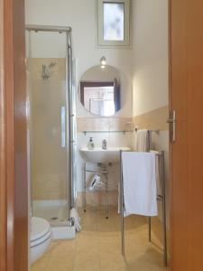 a bathroom with a shower and a sink and a toilet at Le Casette in Santa Flavia +52 photos