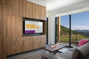 a living room with a tv and a couch at YOTELPAD Park City in Park City