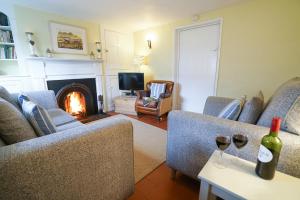 a living room with two couches and a fire place at Aldeburgh Cottage in Aldeburgh