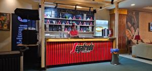 a woman standing behind a bar in a restaurant at Orange County Belek in Belek