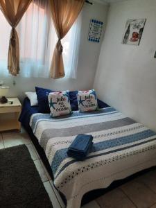 a bed with two pillows on it in a room at Habitaciones en pensión en centro de Iquique in Iquique
