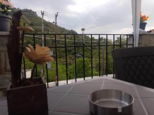 a balcony with a table and a view of a hill at Akis Apartments in Mariaí