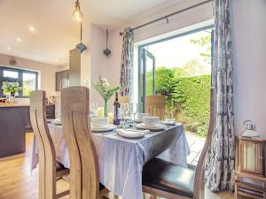a dining room and kitchen with a table and chairs at Araglin in Worstead