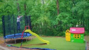 a man is standing on a playground at Bungalows Dani in Kamchia