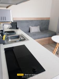 a kitchen with a sink and a couch at Summer Feelings in Skala Sotiros