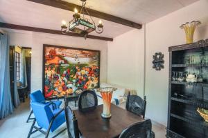 a dining room with a painting on the wall at Mikaso Hotel in San Pedro La Laguna