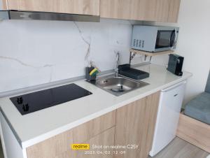 a kitchen with a sink and a computer on a counter at Summer Feelings in Skala Sotiros