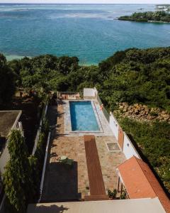 an overhead view of a swimming pool and the ocean at 2 bedroom Apartment -Villa Ibiza in Trou d'Eau Douce