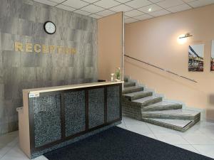 a lobby with stairs and a sign that reads reception at ФИЕСТА in Hora