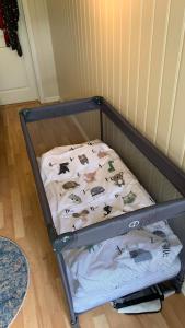 a small bed with a sheet with animals on it at Solvik #apartment #Loen in Loen