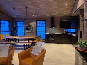 a kitchen and dining room with a table and chairs at Stryn Mountain Lodge in Stryn