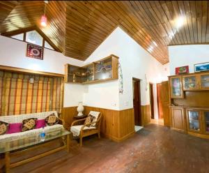 a living room with a couch and a table at Woods Luxury Homestay in Nainital