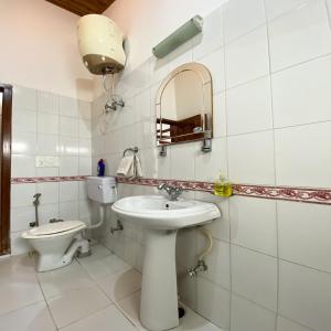 a bathroom with a sink and a toilet at Woods Luxury Homestay in Nainital