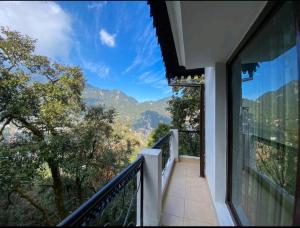 a balcony with a view of the mountains at Woods Luxury Homestay in Nainital