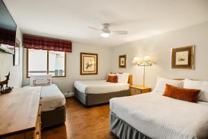 a hotel room with two beds and a window at Shadowbrook 402 in Snowmass Village