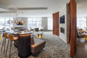 a living room with a couch and a fireplace at SpringHill Suites by Marriott Bloomington in Bloomington