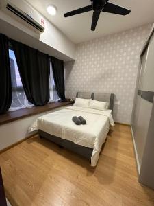 a bedroom with a bed with a ceiling fan at Flowers @ Country Garden Danga Bay in Johor Bahru