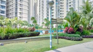 a street sign in a park with tall buildings at Flowers @ Country Garden Danga Bay in Johor Bahru