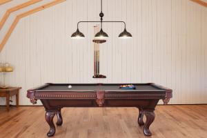 a pool table in a room with two lights at Villa Les Flots: Breathtaking view of St Lawrence in La Malbaie