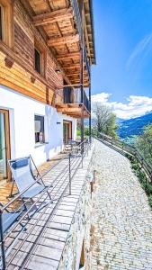 a porch of a house with chairs on it at Tschott Hof in Villandro