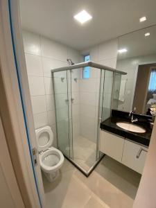 een badkamer met een douche, een toilet en een wastafel bij Edifício Promenade II Apt 404-Mandi Hospitalidade in Maceió