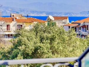 a group of houses and trees in a city at Villa Trousas Kassiopi with private pool in Kassiopi