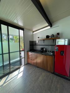 a kitchen with a red refrigerator and wooden cabinets at Studio C Minerva zona residencial 1er piso in Guadalajara