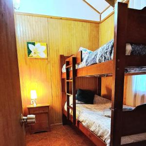 a bedroom with two bunk beds in a room at Tuava Lodge in Hanga Roa