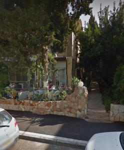 a stone wall in front of a house at Modern Studio Central Haifa Free WiFi דירת נופש מאובזרת בחיפה in Haifa