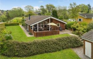 a house with a large backyard with a deck at Awesome Home In Ebeltoft With Kitchen in Ebeltoft