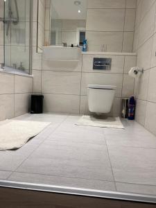 a bathroom with a toilet and a sink at Perfect home in Barking