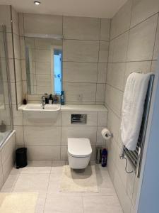 a bathroom with a toilet and a sink at Perfect home in Barking