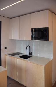 a kitchen with a sink and a microwave at tiny house in Rotterdam