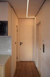 a hallway with a white door in a kitchen at tiny house in Rotterdam