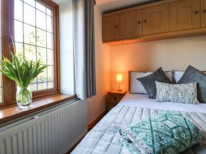 a bedroom with a bed and a window at Adelaide Cottage in Ashbourne +14 photos