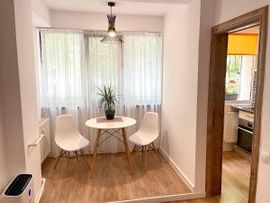 a small dining room with a table and chairs at Studio Dristor - foarte curat si frumos in Bucharest