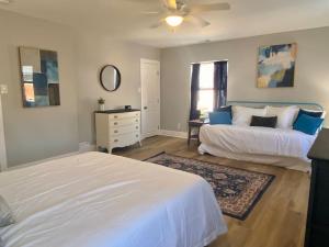 a bedroom with two beds and a dresser in it at SJ Suburban HiDeAwAy 