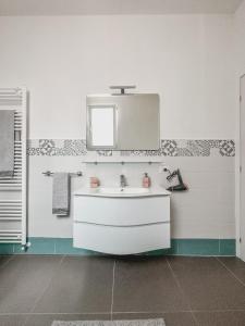 a bathroom with a white sink and a mirror at Casa con giardino, La casa di Sophie, Arona in Arona