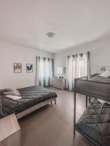a bedroom with two beds in a room at Casa con giardino, La casa di Sophie, Arona in Arona