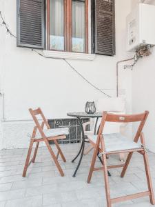 two chairs and a table on a patio at Casa con giardino, La casa di Sophie, Arona in Arona